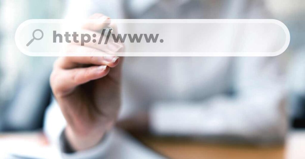 Person writing a website address on screen